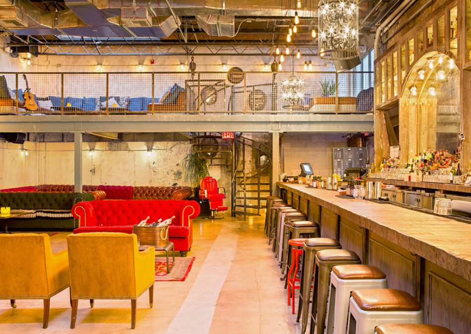 Two-level bar with cozy lounge area and vintage-style decor.

