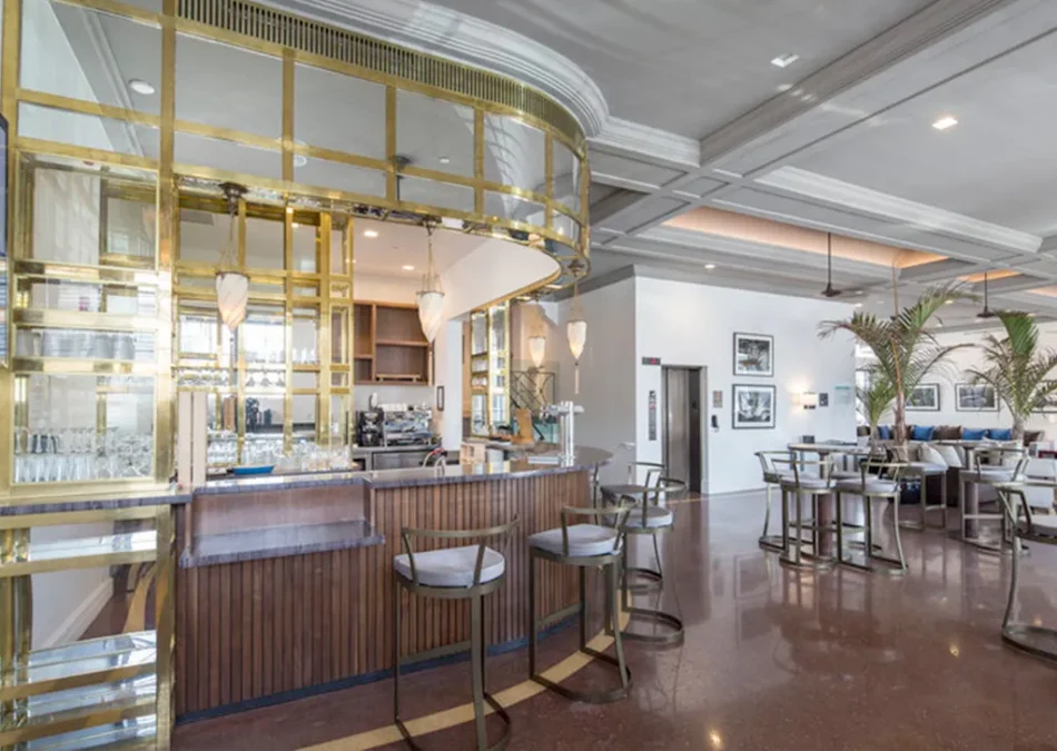 Glamorous bar with gold accents and custom wood paneling.