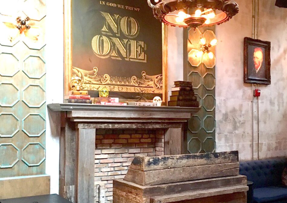 Rustic fireplace with stacked books, skull decor, and a bold “NO ONE” wall sign.